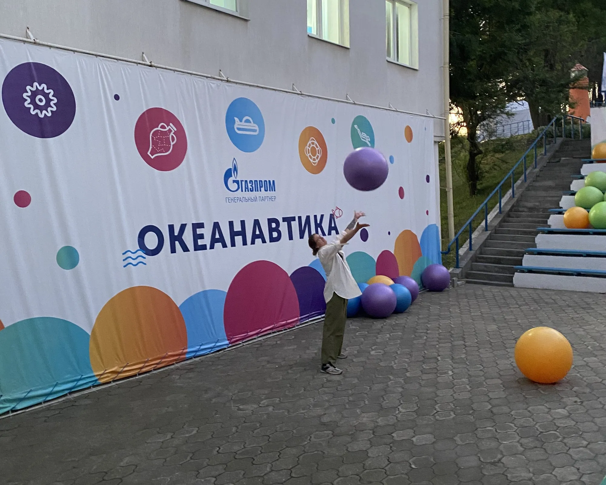 Viktoryia tossing a ball in front of the Oceanautica banner at the camp